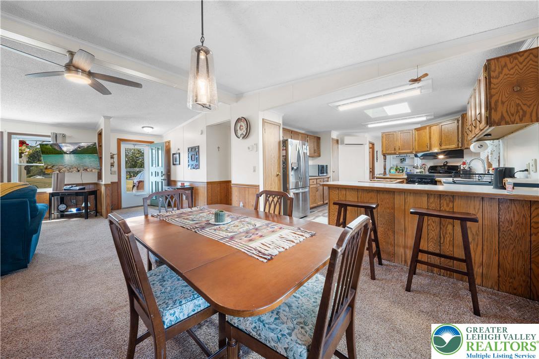6149 Snyders Church Road, Unit TRL#28 Bath, PA 18014 - Photo 10 of 43 a dining room with a table chairs and kitchen view