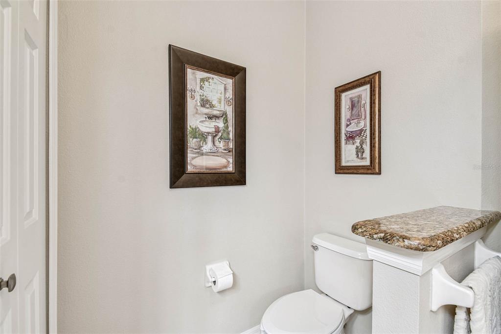 12202 Aaron Terrace Trinity, FL 34655 - Photo 25 of 41 a bathroom with a toilet sink and mirror