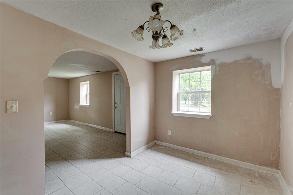 146 State Line Road Rossville, GA 30741 - Photo 5 of 18 en empty room with a chandelier fan and windows
