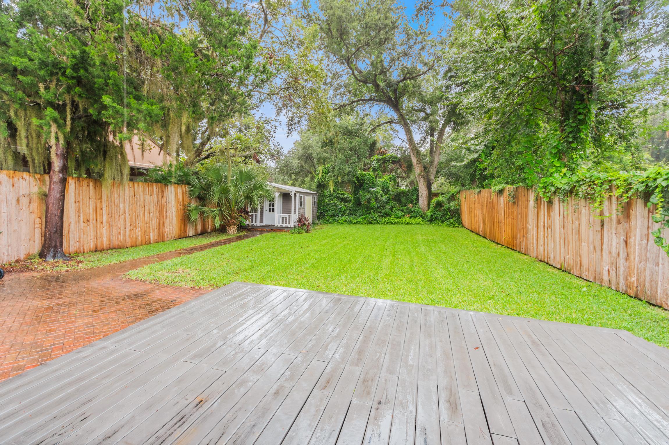 11 Hildreth Drive St. Augustine, FL 32084 - Photo 26 of 42 a view of a backyard with a small deck and a large tree
