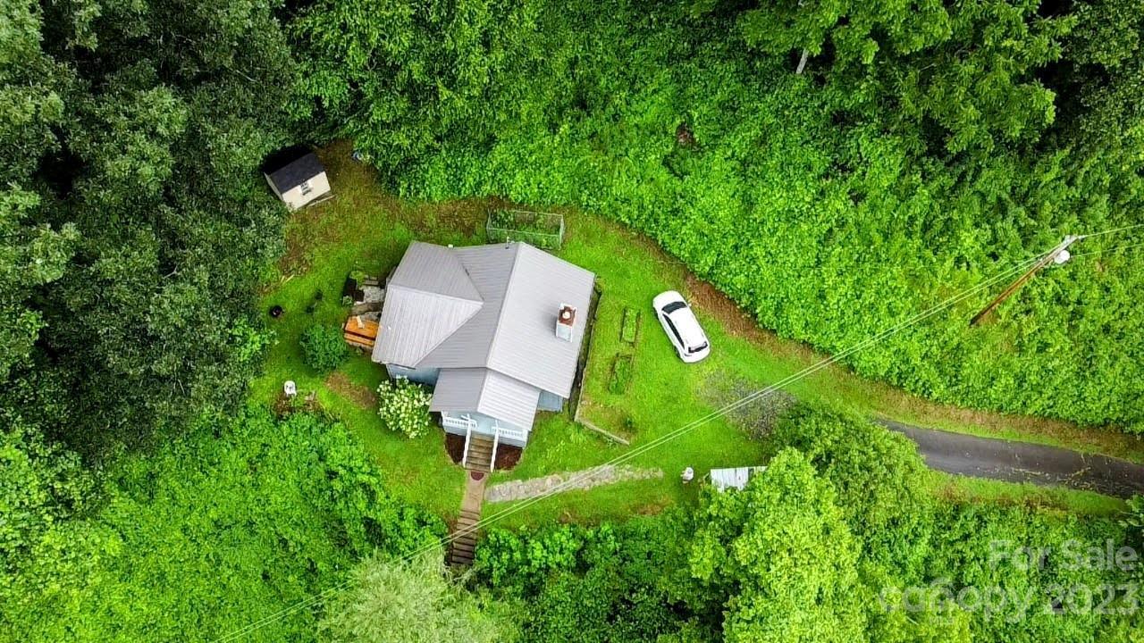 6115 Skyland Drive Sylva, NC 28779 - Photo 4 of 15 an aerial view of a house with a yard and trees all around