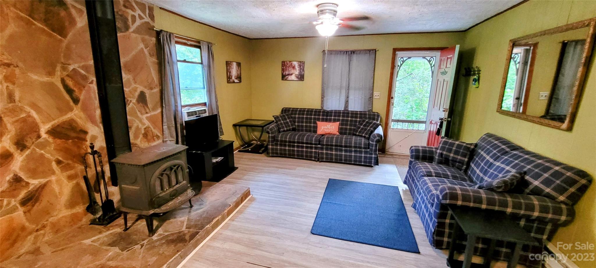 6115 Skyland Drive Sylva, NC 28779 - Photo 8 of 15 a living room with furniture fireplace and flat screen tv