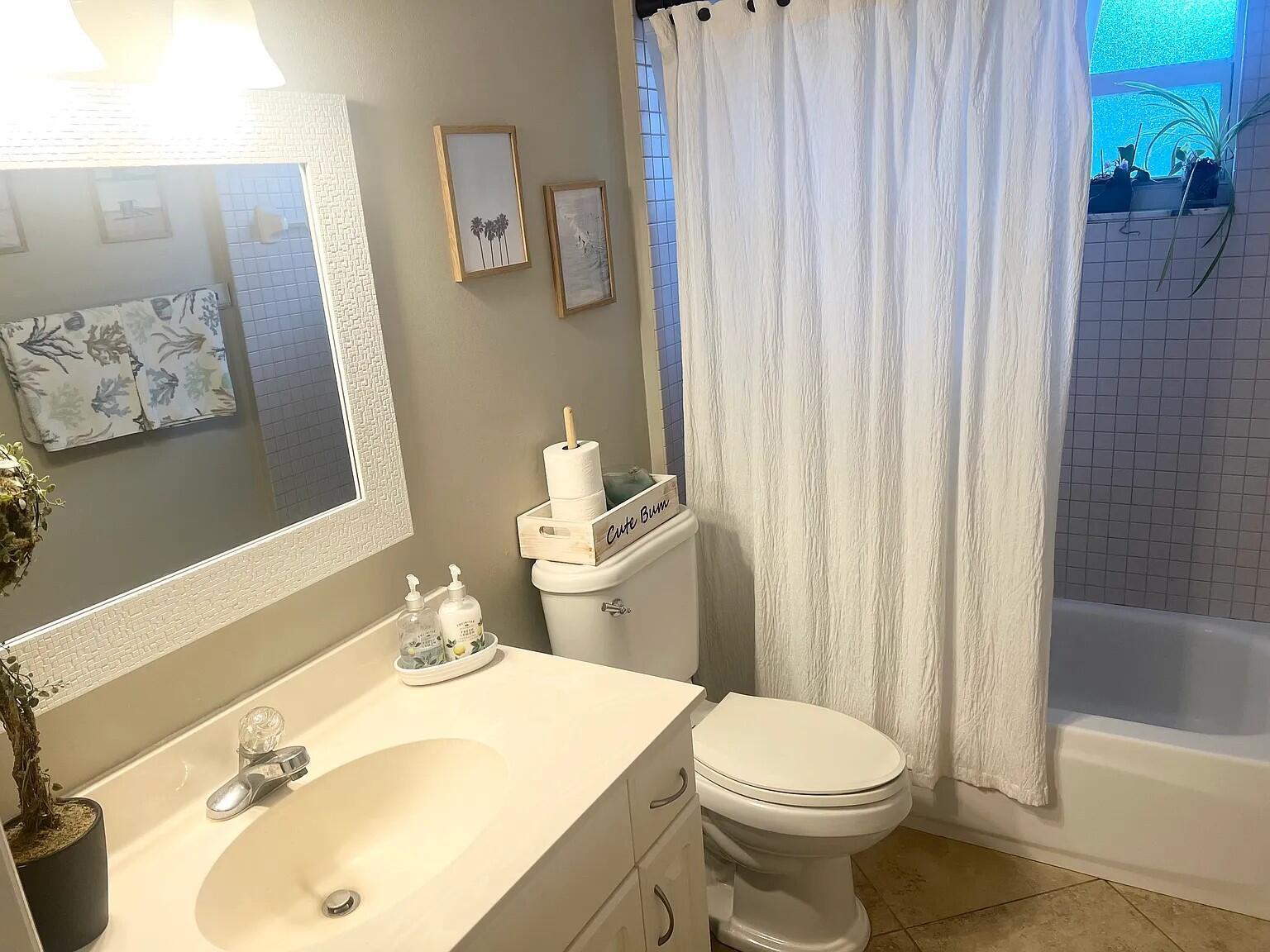 6435 Foster Street Jupiter, FL 33458 - Photo 4 of 8 a bathroom with a sink toilet and shower