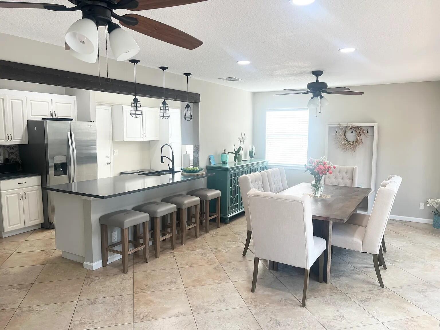 6435 Foster Street Jupiter, FL 33458 - Photo 6 of 8 a dining table chairs and a kitchen view