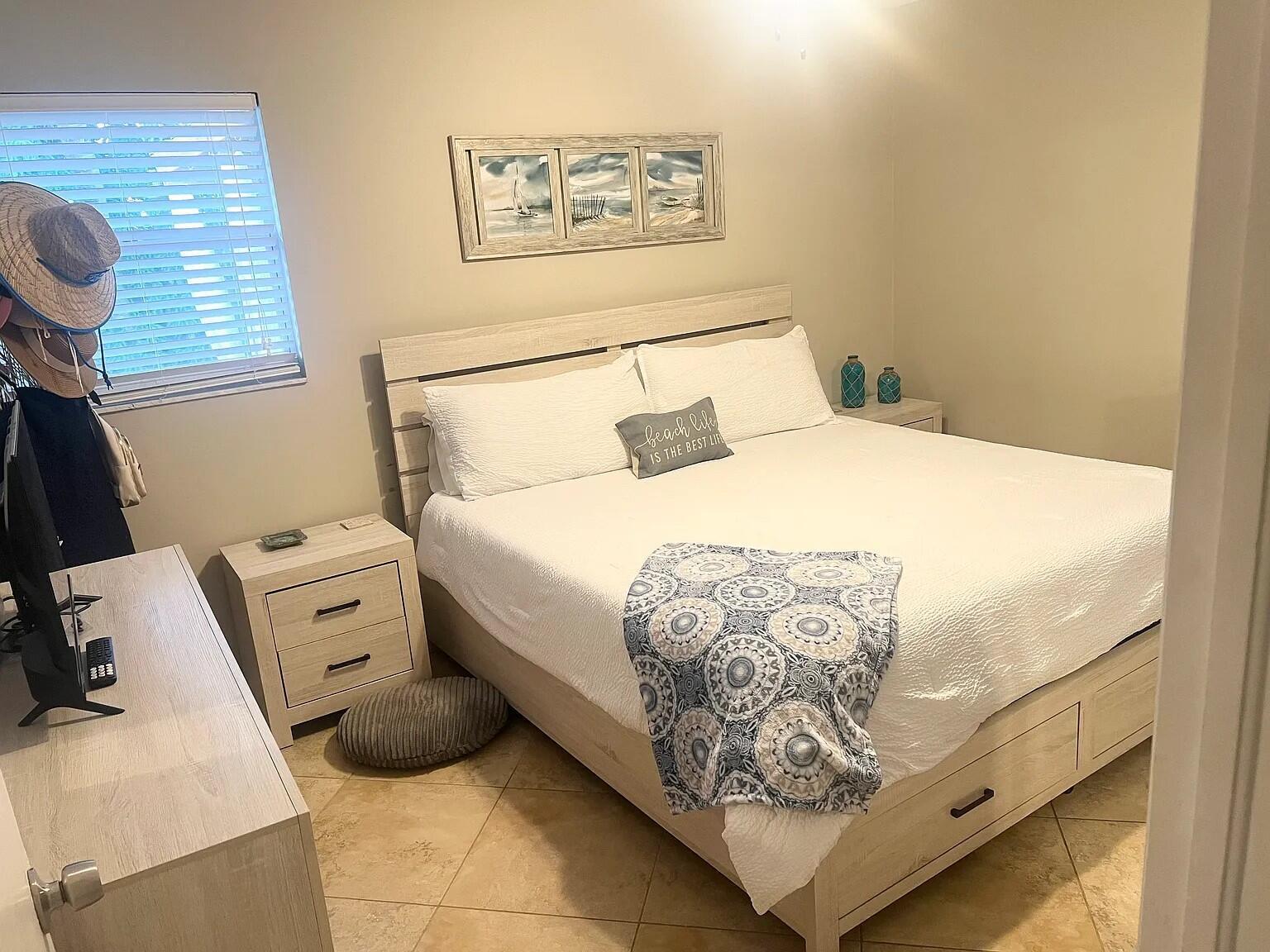 6435 Foster Street Jupiter, FL 33458 - Photo 8 of 8 a bedroom with a bed and cabinets