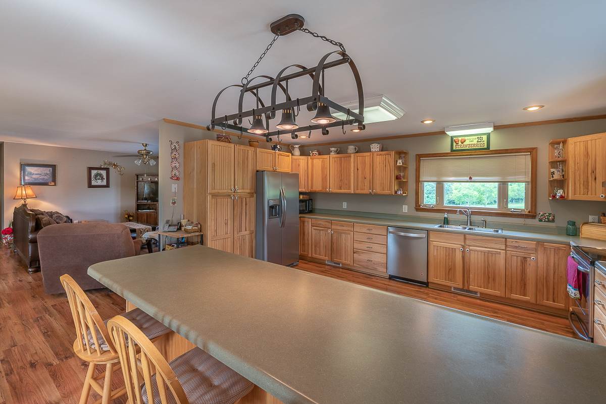 1165 Miller Farm Road Staunton, VA 24401 - Photo 18 of 50 a kitchen with stainless steel appliances a sink a stove top oven a counter space and cabinets
