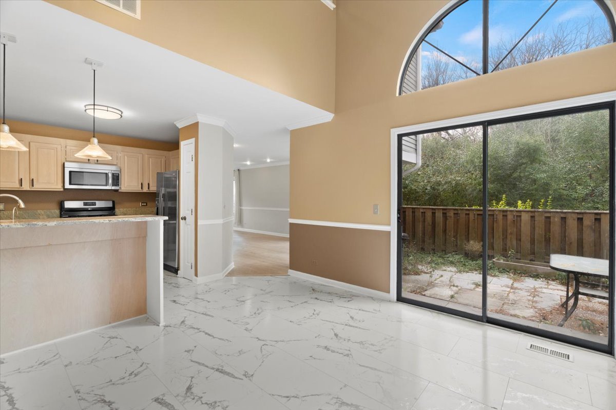 8 Hastings Lane Lincolnshire, IL 60069 - Photo 11 of 29 a view of a kitchen with wooden floor and electronic appliances