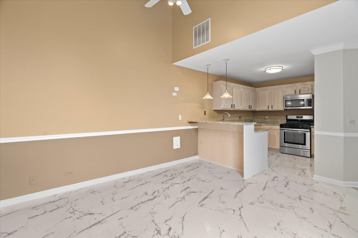 8 Hastings Lane Lincolnshire, IL 60069 - Photo 12 of 29 a kitchen with stainless steel appliances granite countertop a refrigerator a stove and a sink