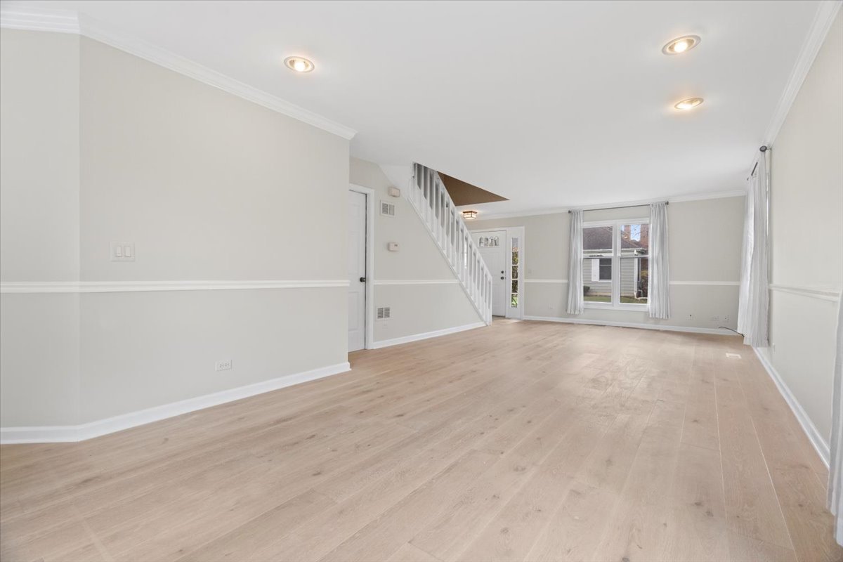 8 Hastings Lane Lincolnshire, IL 60069 - Photo 3 of 29 wooden floor in an empty room with a window