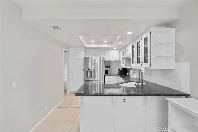 a large kitchen with kitchen island a sink stainless steel appliances and cabinets