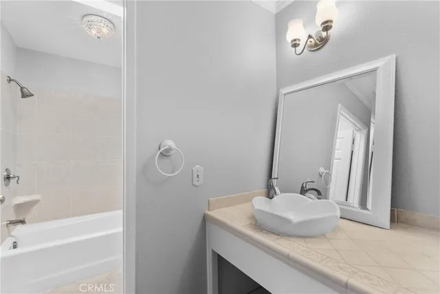 a bathroom with a tub sink and mirror