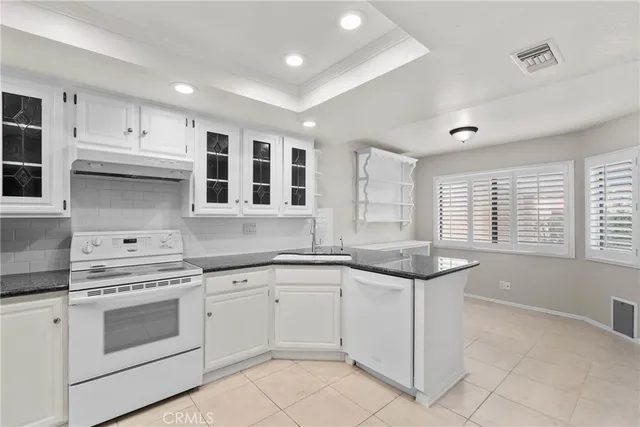 a kitchen that has a sink and cabinets