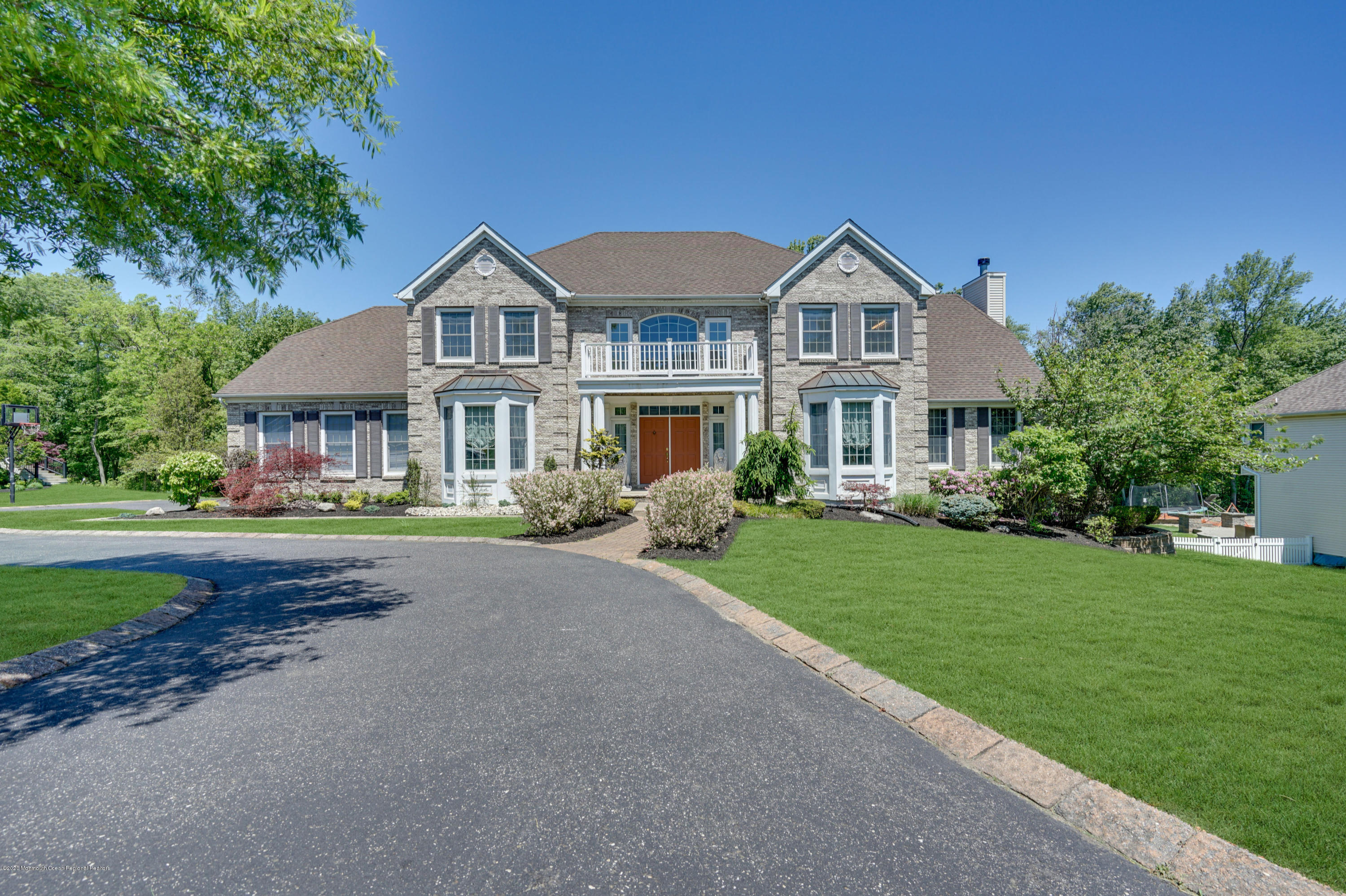 27 Northwoods Road Asbury Park, NJ 07712 - Photo 1 of 76 a front view of a house with a yard and garage