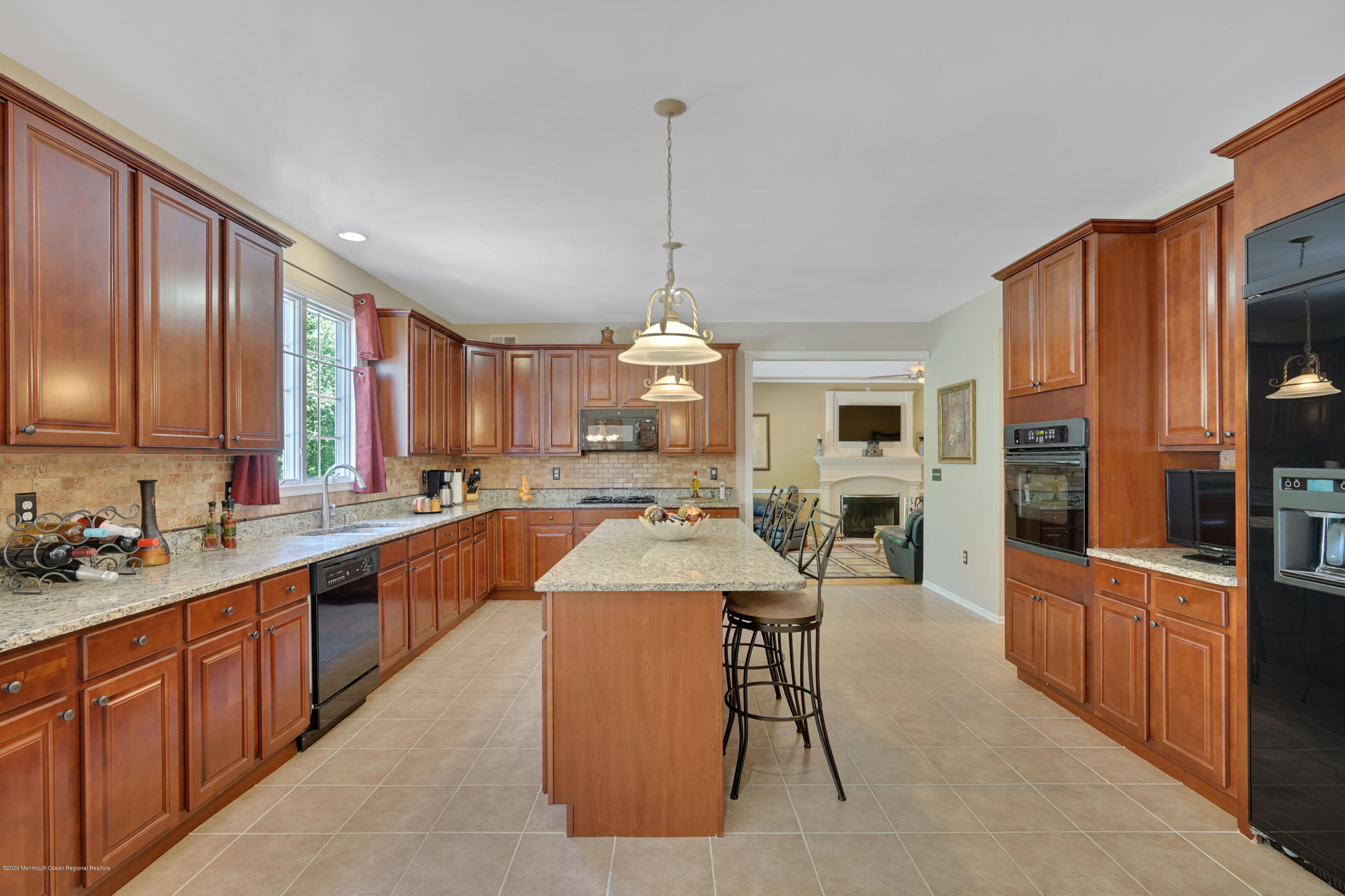 27 Northwoods Road Asbury Park, NJ 07712 - Photo 19 of 76 a large kitchen with kitchen island granite countertop a large island in the center