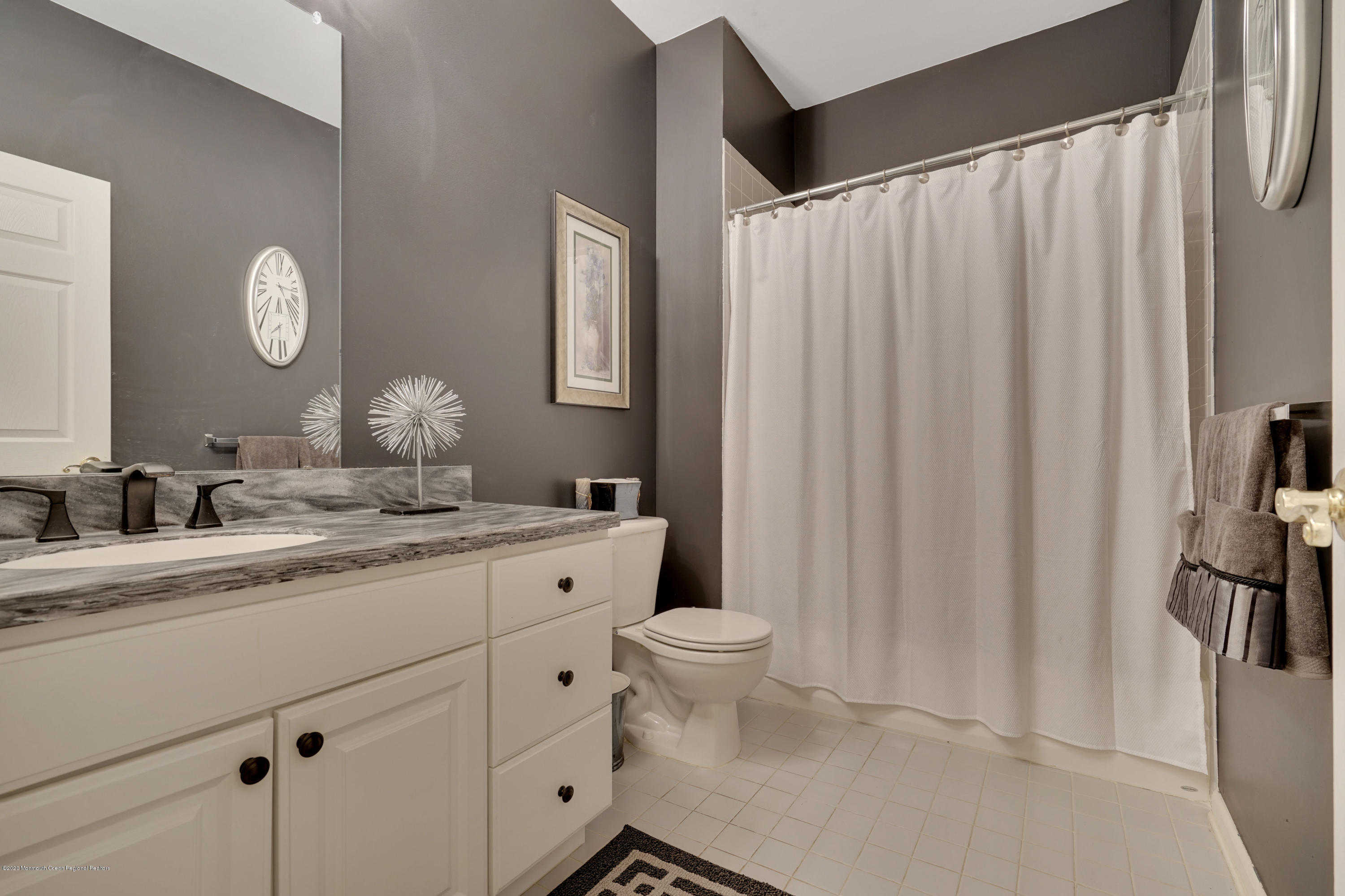 27 Northwoods Road Asbury Park, NJ 07712 - Photo 25 of 76 a bathroom with a granite countertop sink and a mirror