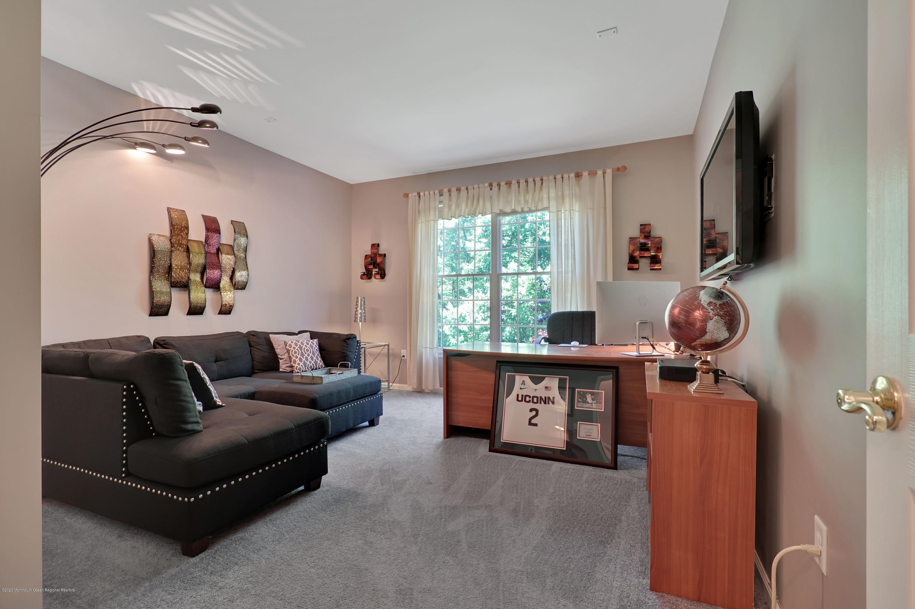 27 Northwoods Road Asbury Park, NJ 07712 - Photo 26 of 76 a living room with furniture and a flat screen tv