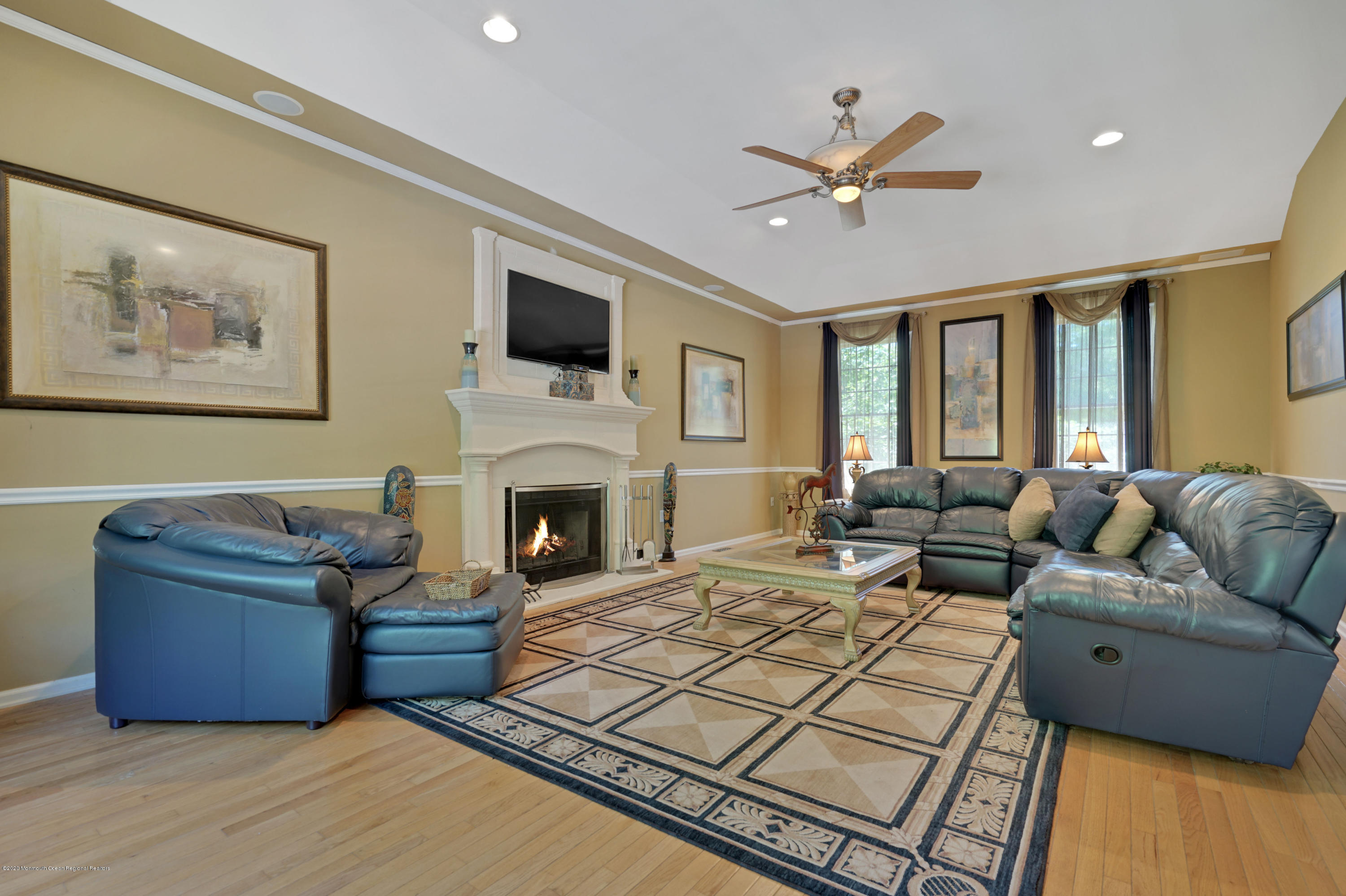 27 Northwoods Road Asbury Park, NJ 07712 - Photo 28 of 76 a living room with furniture a fireplace and a flat screen tv