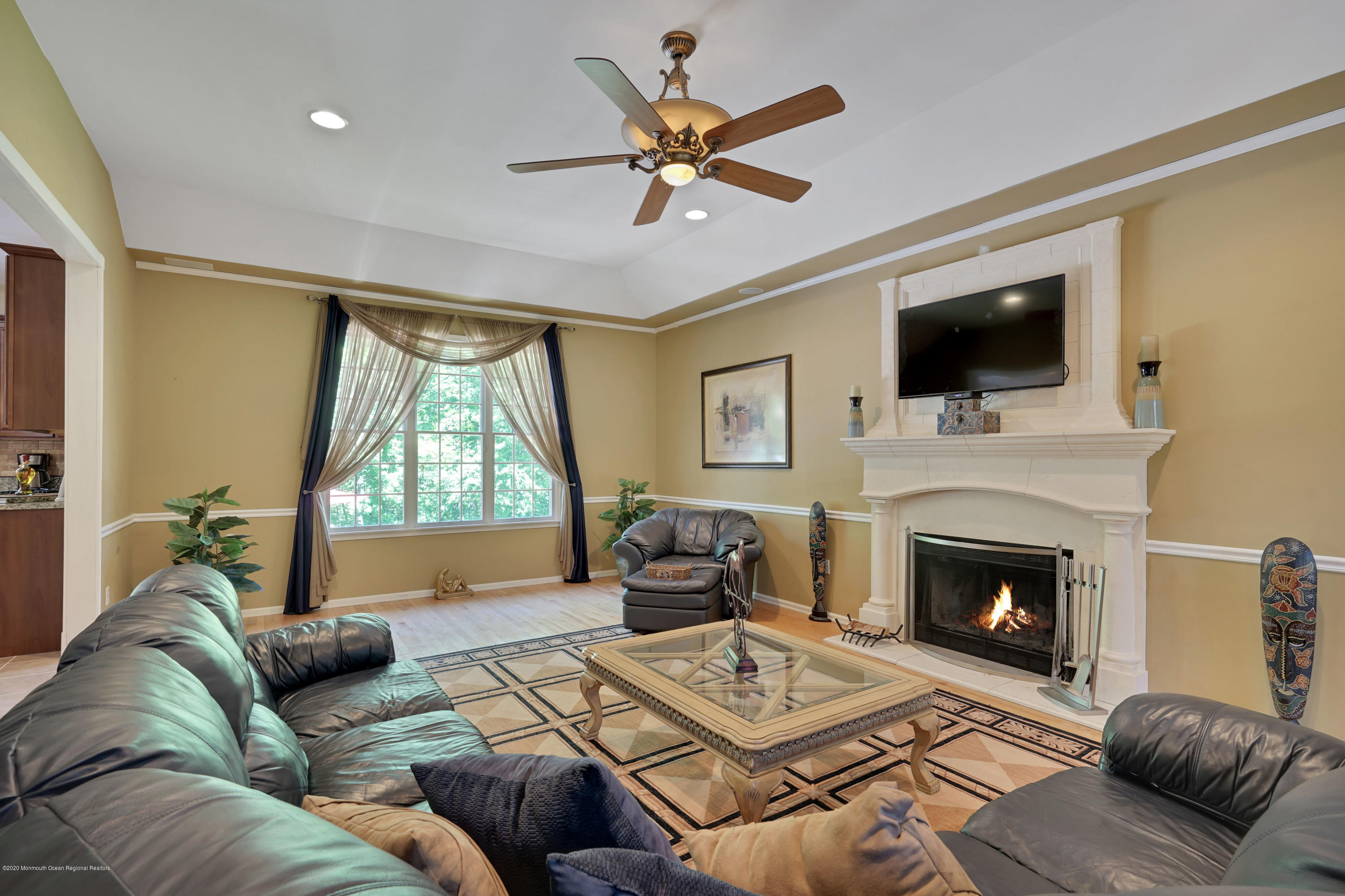 27 Northwoods Road Asbury Park, NJ 07712 - Photo 30 of 76 a living room with furniture a fireplace and a flat screen tv