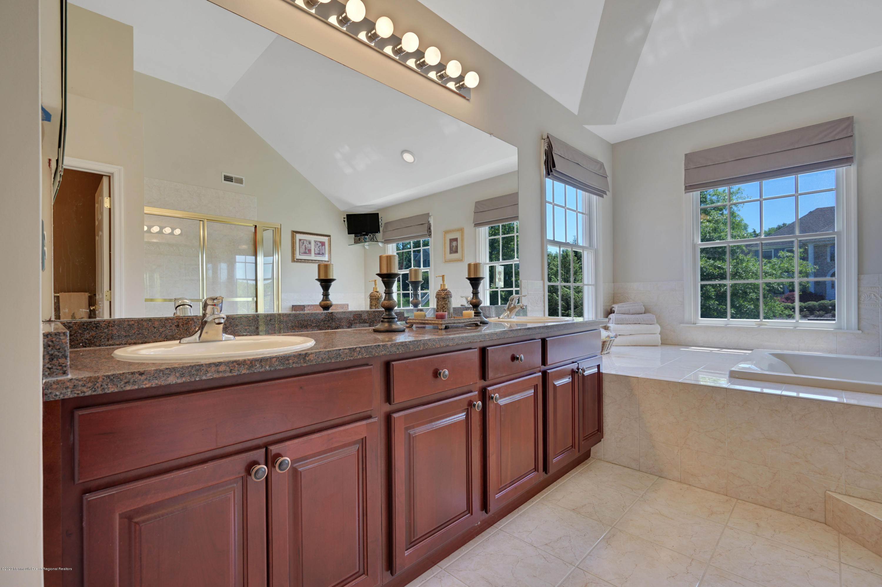 27 Northwoods Road Asbury Park, NJ 07712 - Photo 43 of 76 a bathroom with a granite countertop sink a large mirror and a window