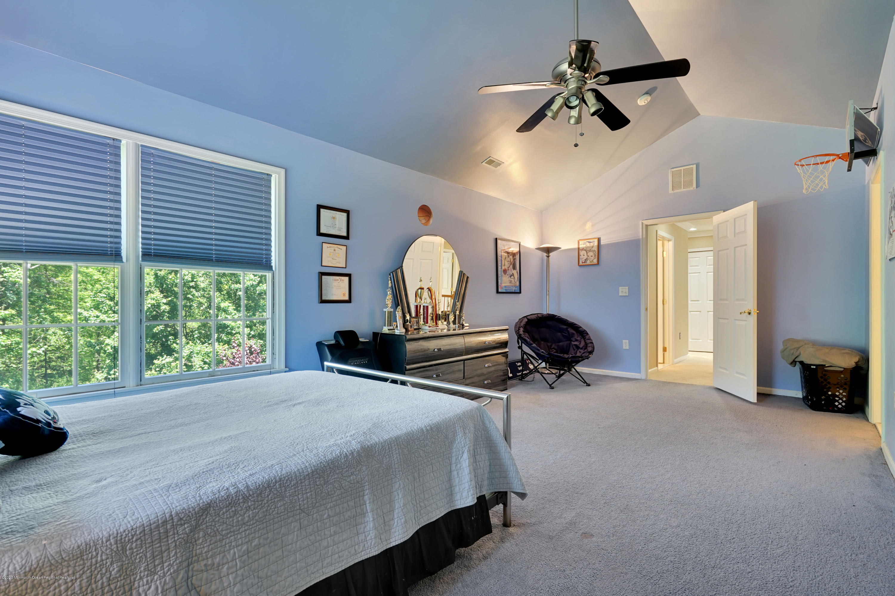 27 Northwoods Road Asbury Park, NJ 07712 - Photo 49 of 76 a bedroom with a bed a large window and a chandelier