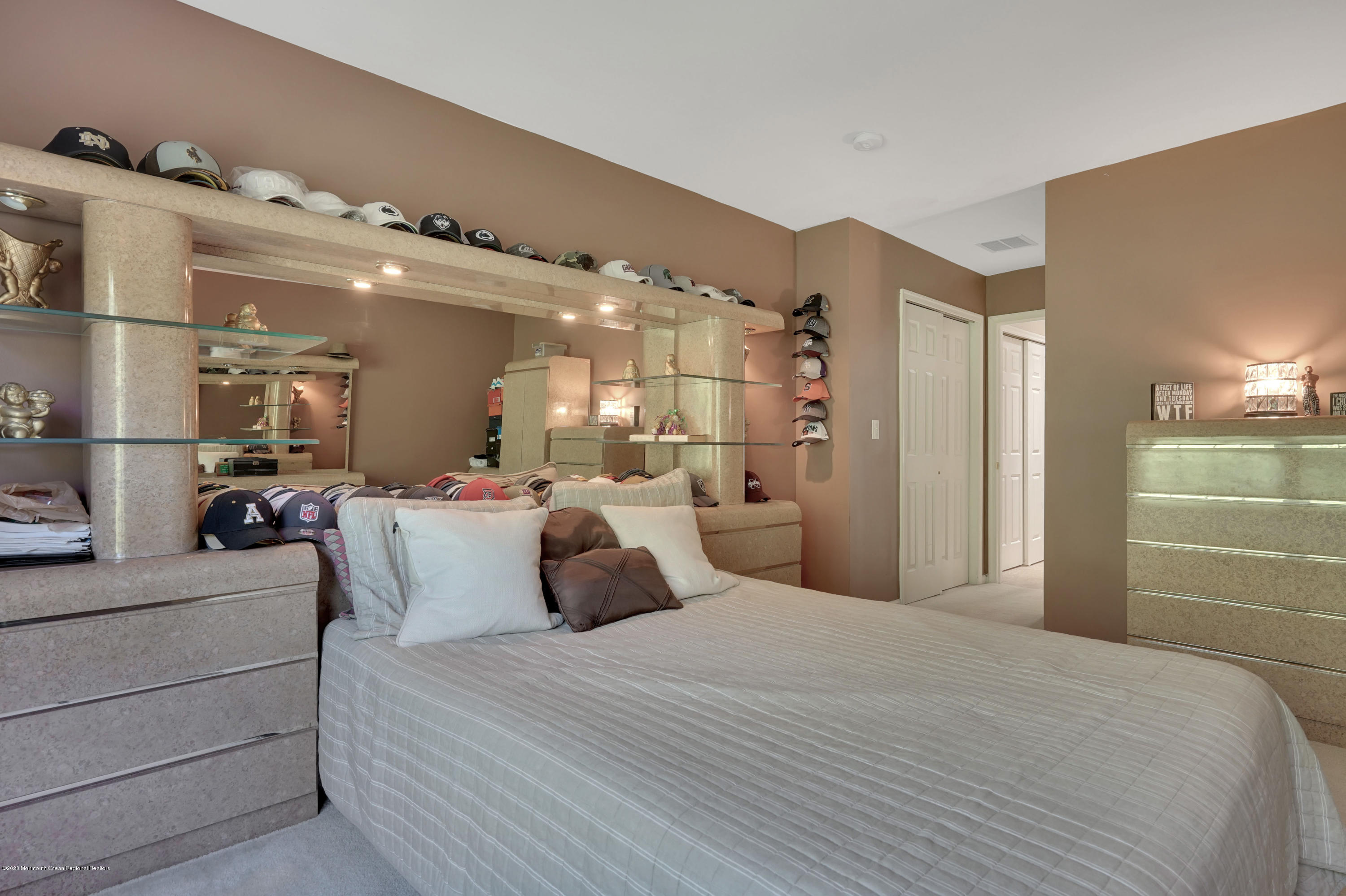 27 Northwoods Road Asbury Park, NJ 07712 - Photo 52 of 76 a bedroom with a large bed and a large mirror
