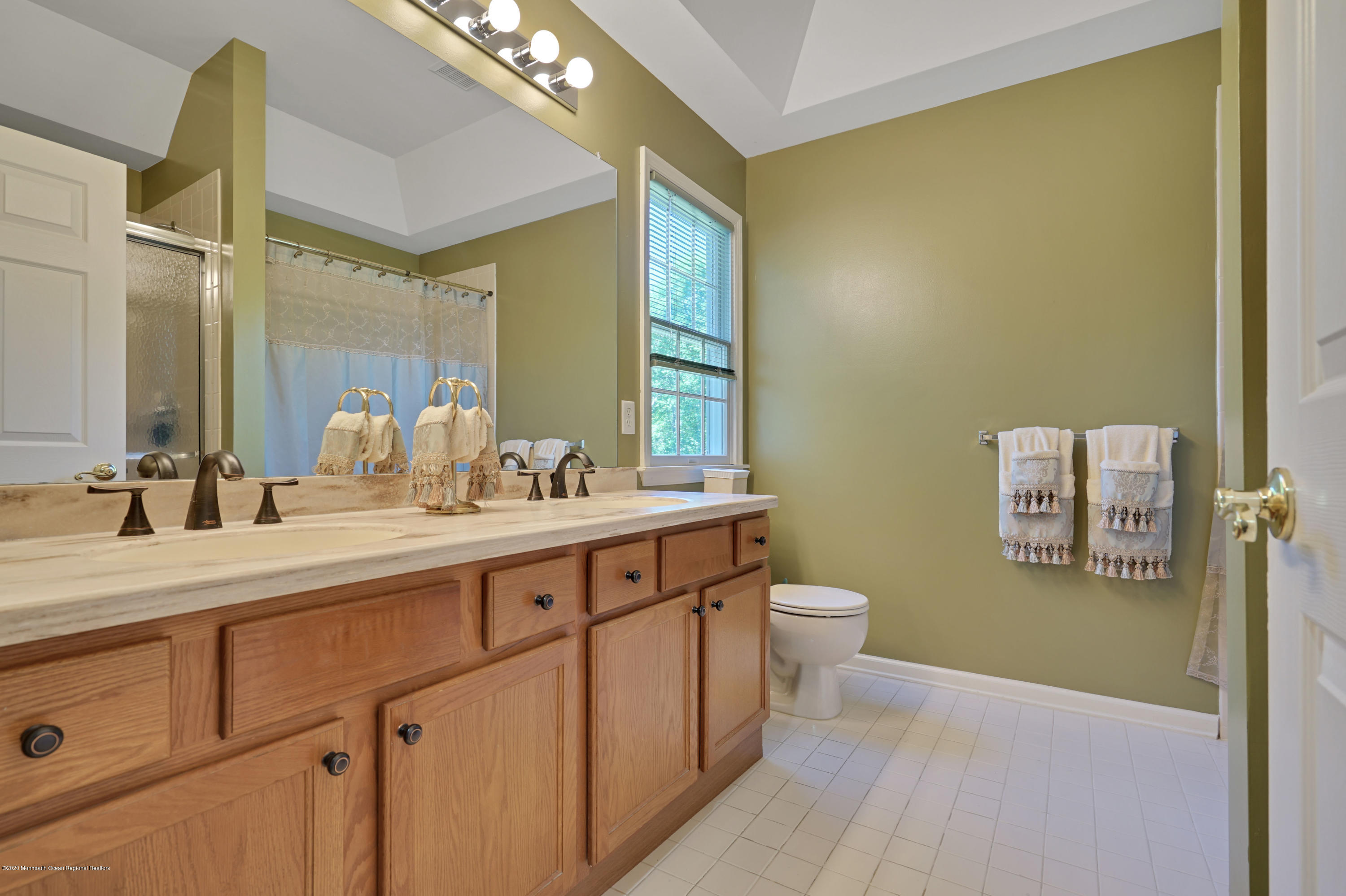 27 Northwoods Road Asbury Park, NJ 07712 - Photo 54 of 76 a spacious bathroom with a double vanity sink a mirror and a toilet