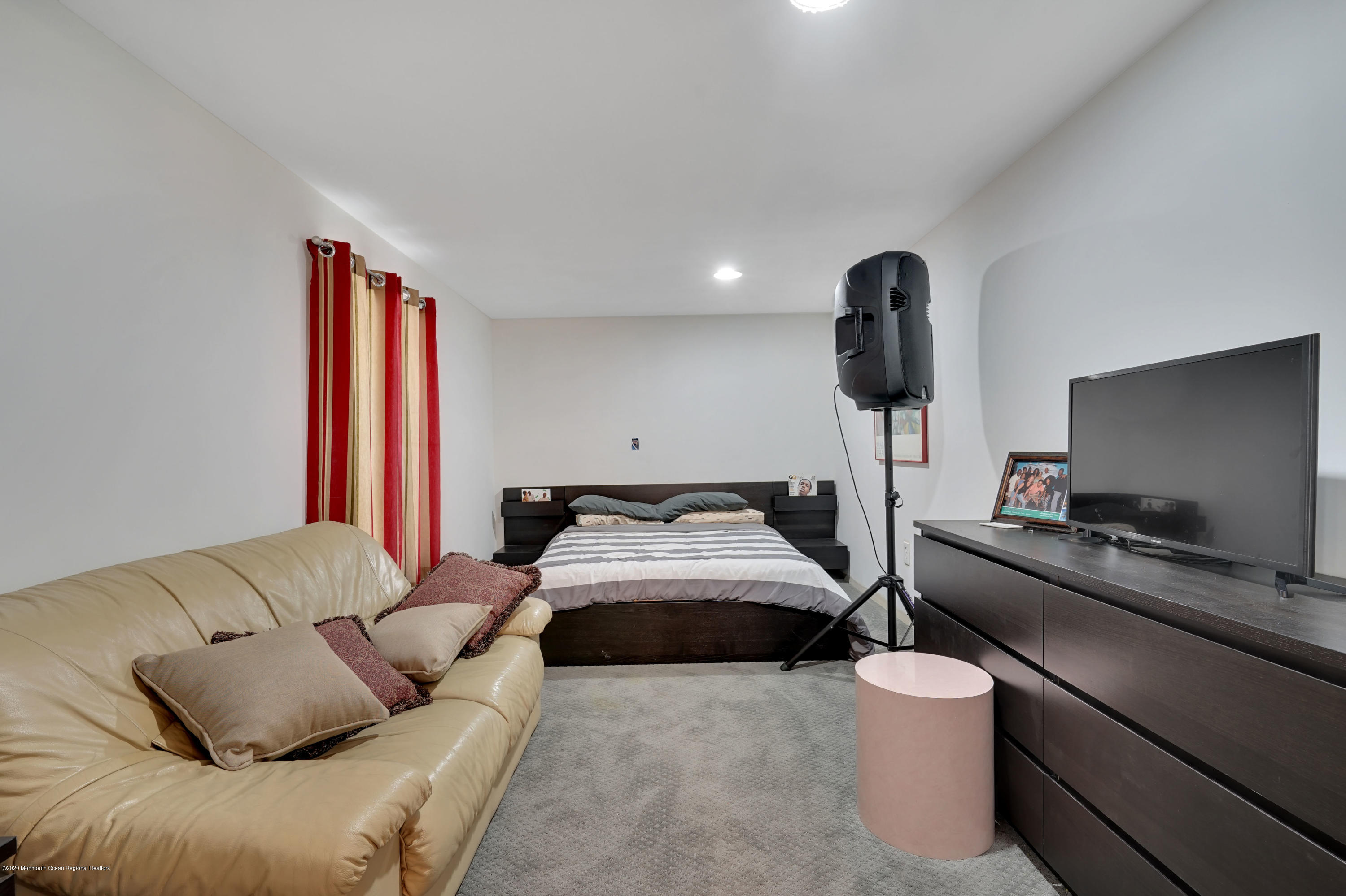 27 Northwoods Road Asbury Park, NJ 07712 - Photo 67 of 76 a bedroom with furniture and a flat screen tv