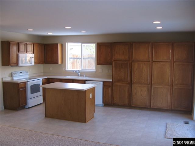 2570 Rio Rico Court Reno, NV 89523 - Photo 4 of 9 a kitchen with stainless steel appliances granite countertop a stove a sink and a refrigerator