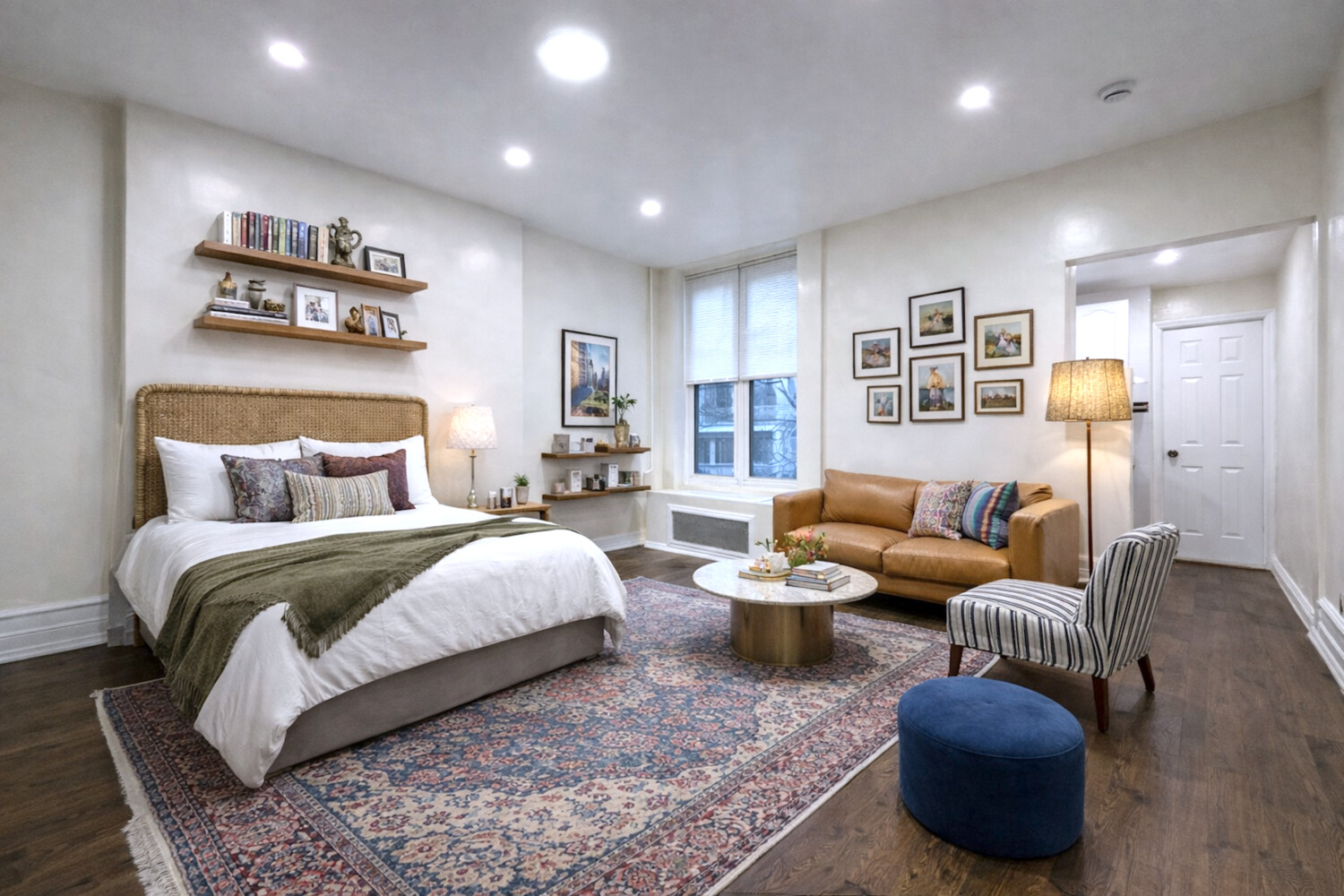 a spacious bedroom with a bed and glass top table