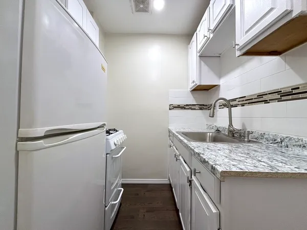 a utility room with a sink a washer and dryer