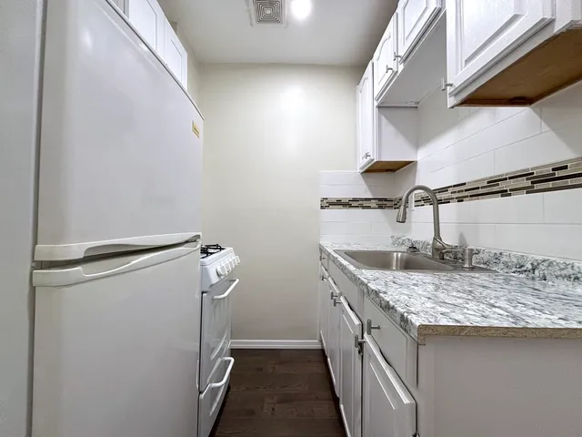 a utility room with a sink a washer and dryer