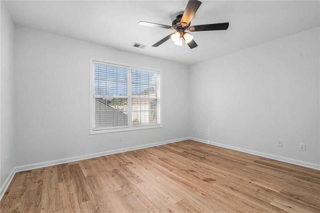 244 Windcroft Circle Northwest Acworth, GA 30101 - Photo 11 of 18 wooden floor in an empty room with a window