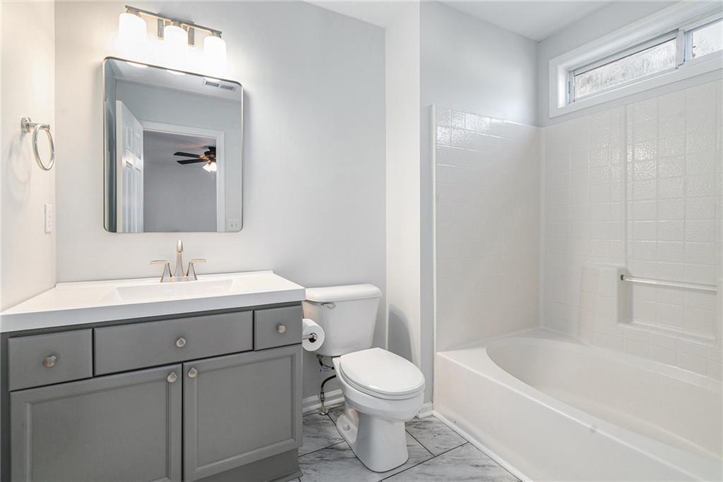 244 Windcroft Circle Northwest Acworth, GA 30101 - Photo 13 of 18 a bathroom with a sink a toilet and shower