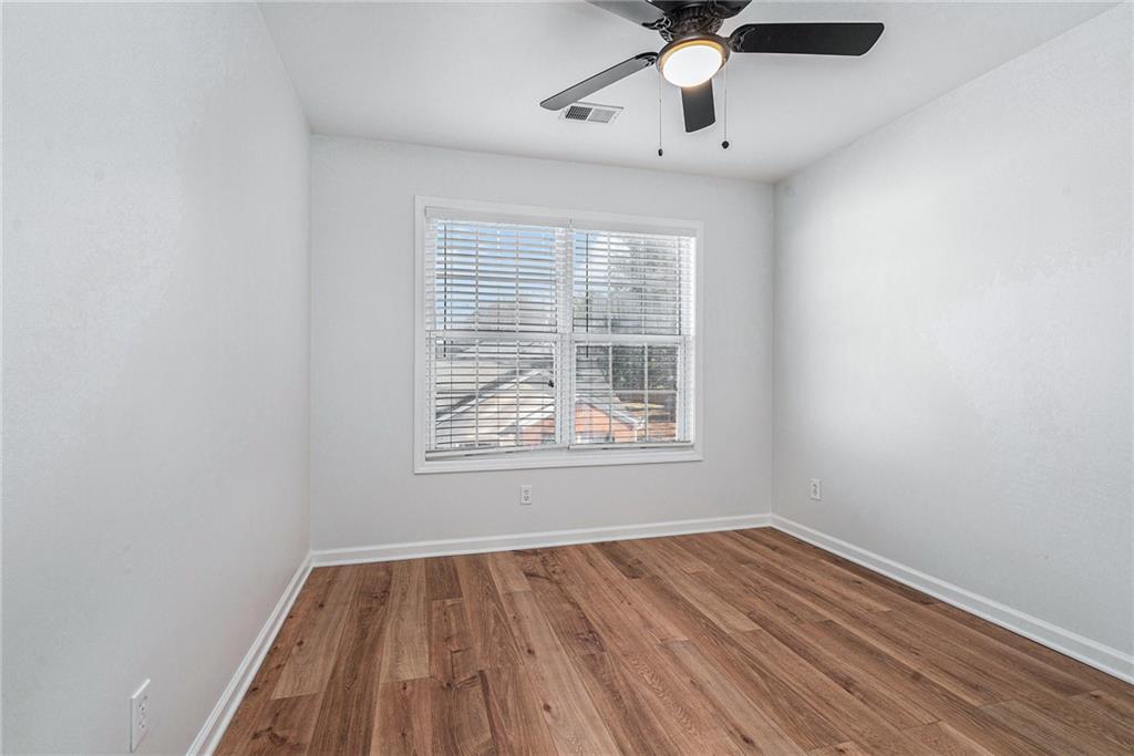 244 Windcroft Circle Northwest Acworth, GA 30101 - Photo 14 of 18 wooden floor in an empty room with a window