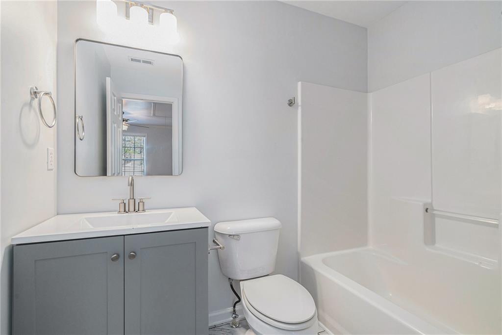 244 Windcroft Circle Northwest Acworth, GA 30101 - Photo 17 of 18 a white toilet sitting next to a bathroom sink