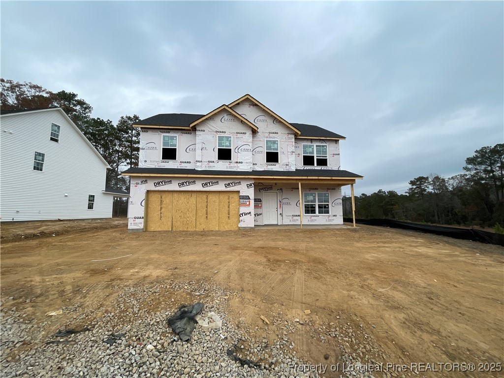 a view of a house with wooden fence