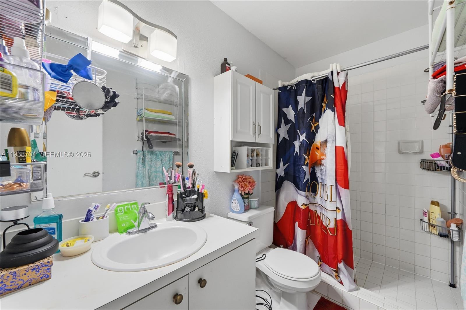 17901 Northwest 68th Avenue, Unit R206 Hialeah, FL 33015 - Photo 11 of 21 a bathroom with a sink vanity mirror and toilet
