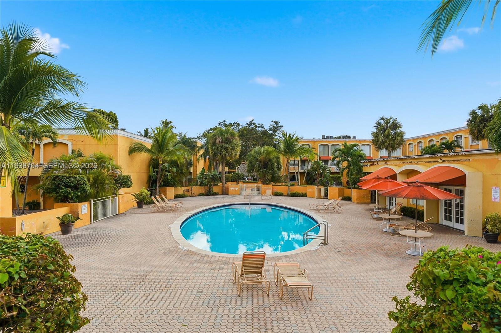 17901 Northwest 68th Avenue, Unit R206 Hialeah, FL 33015 - Photo 18 of 21 a view of swimming pool with outdoor seating