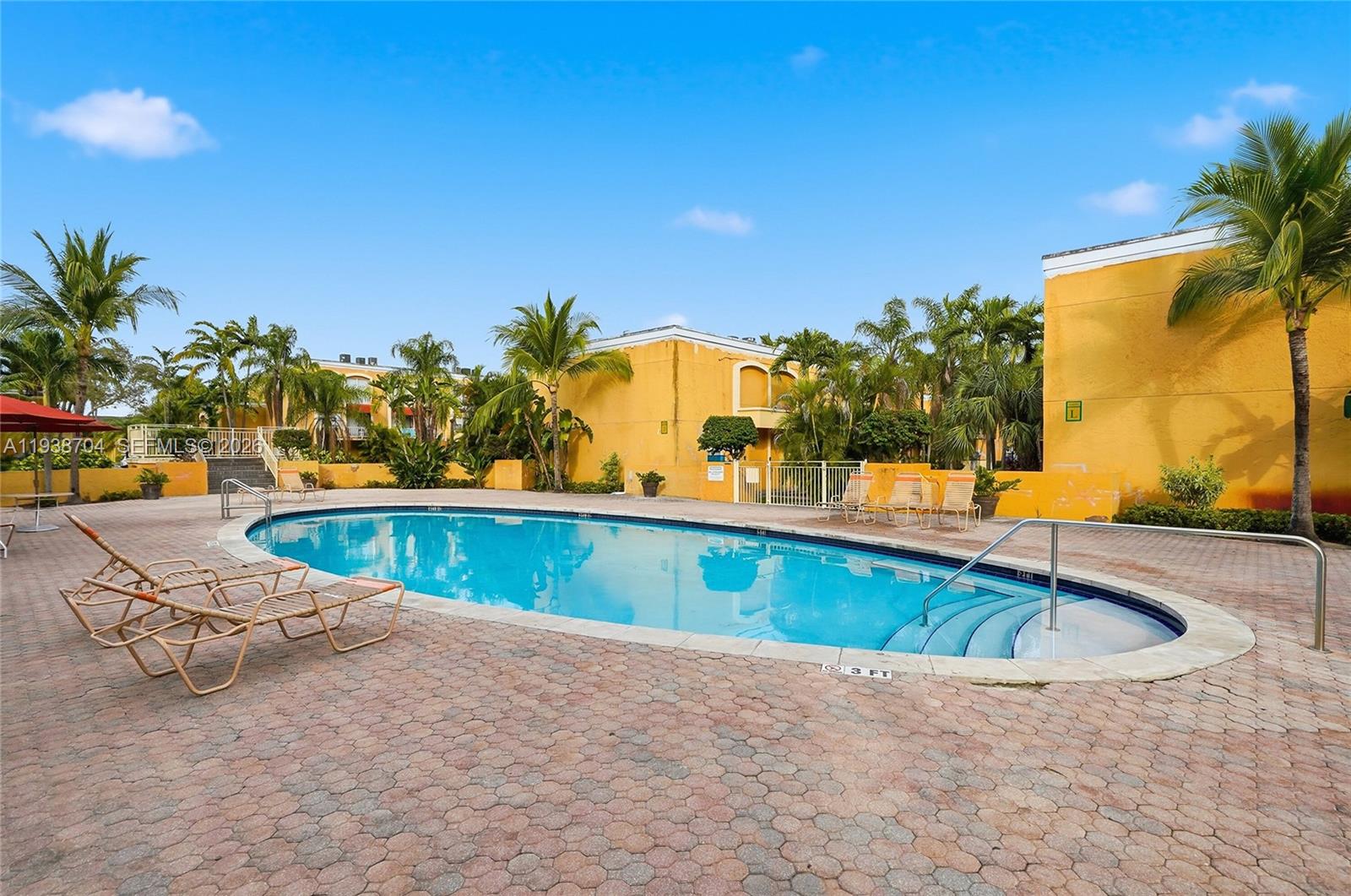 17901 Northwest 68th Avenue, Unit R206 Hialeah, FL 33015 - Photo 19 of 21 swimming pool with outdoor seating