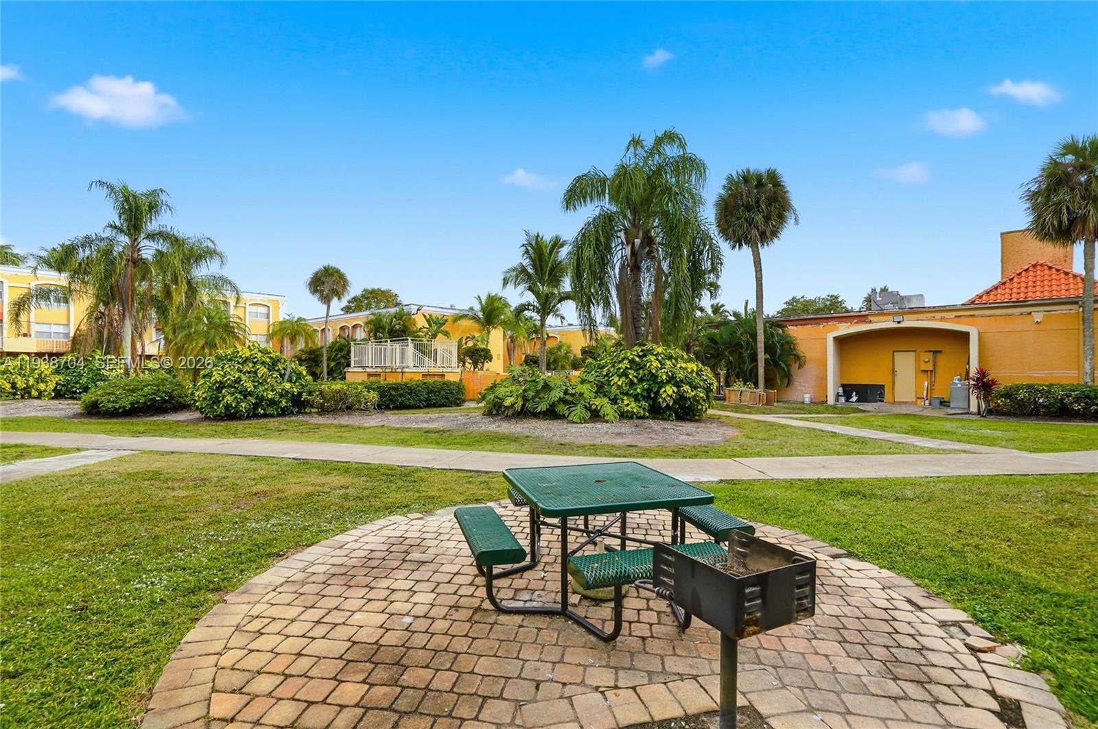 17901 Northwest 68th Avenue, Unit R206 Hialeah, FL 33015 - Photo 20 of 21 a front view of a house with garden