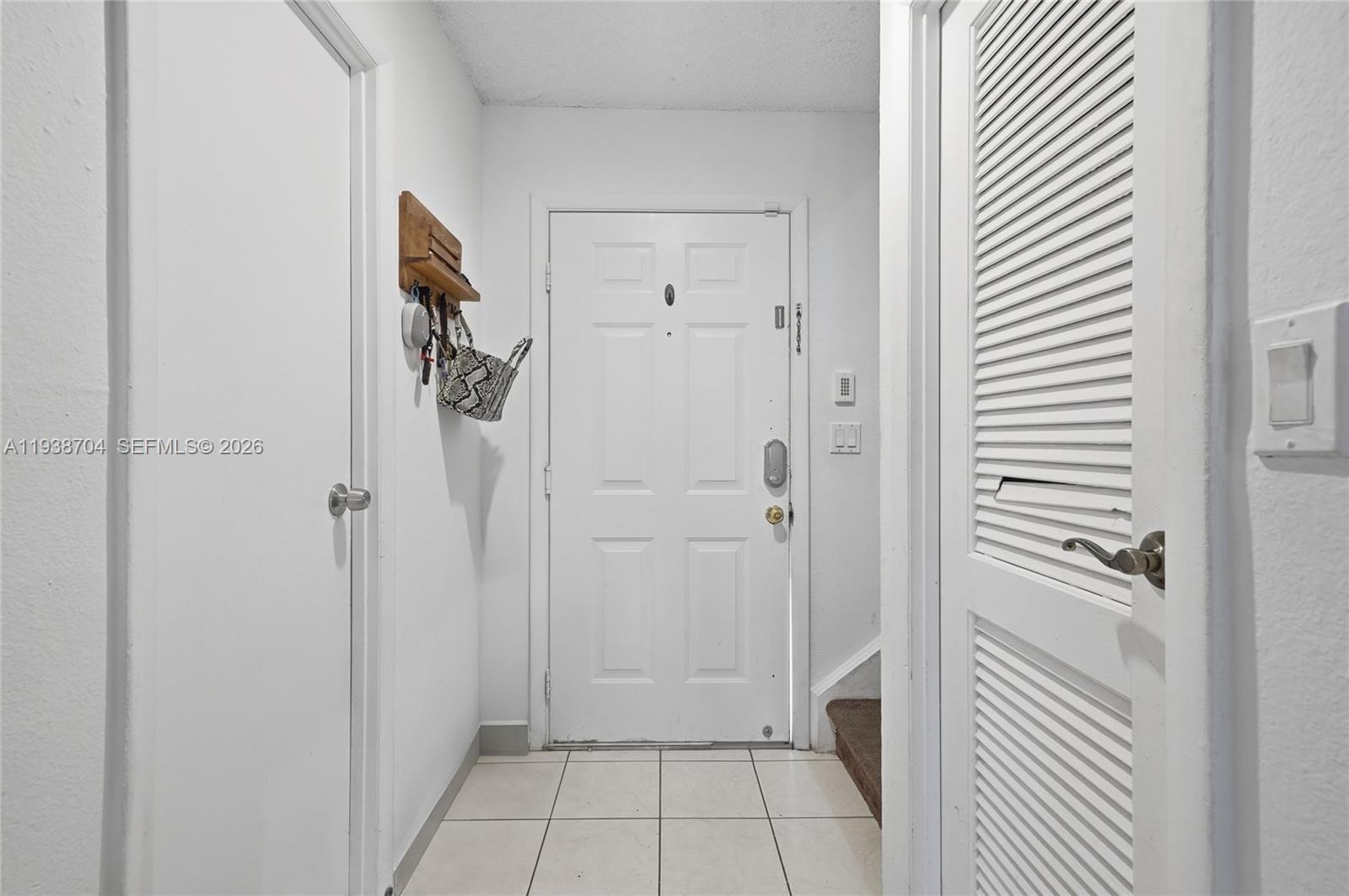 17901 Northwest 68th Avenue, Unit R206 Hialeah, FL 33015 - Photo 2 of 21 a bathroom with a shower