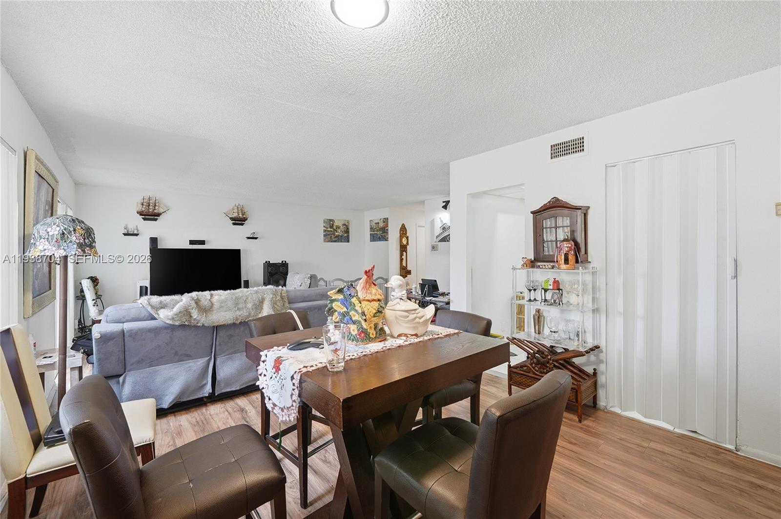 17901 Northwest 68th Avenue, Unit R206 Hialeah, FL 33015 - Photo 5 of 21 a living room with furniture and a fireplace