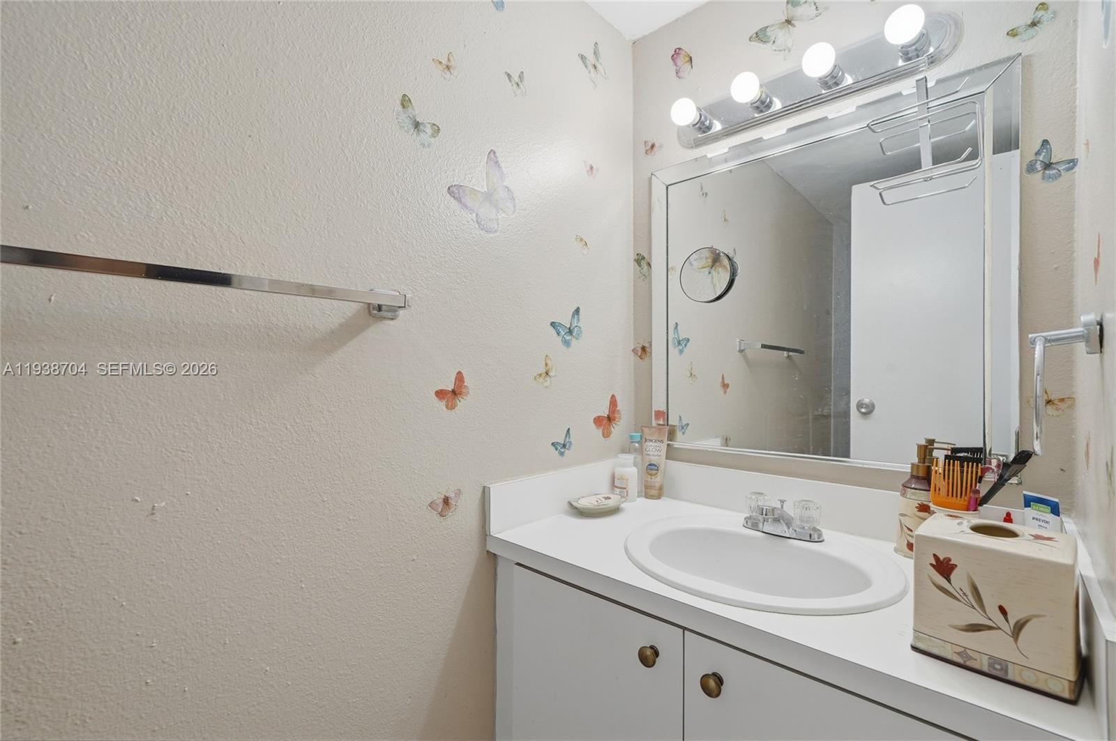 17901 Northwest 68th Avenue, Unit R206 Hialeah, FL 33015 - Photo 6 of 21 a bathroom with a sink vanity mirror and shower