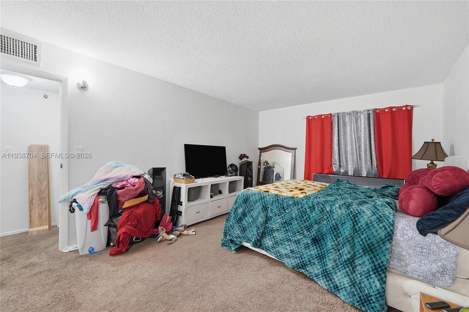 17901 Northwest 68th Avenue, Unit R206 Hialeah, FL 33015 - Photo 10 of 21 a living room with furniture and a flat screen tv