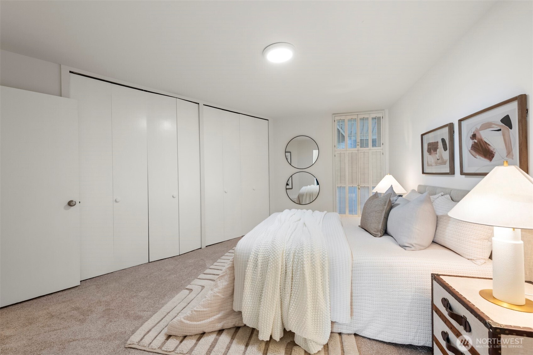 500 West Olympic Place, Unit 203 Seattle, WA 98119 - Photo 13 of 35 a bedroom with a bed and a lamp on table