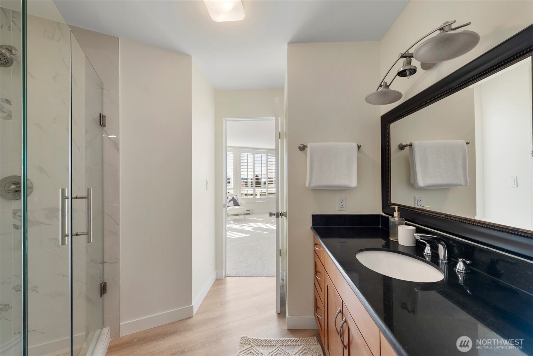 500 West Olympic Place, Unit 203 Seattle, WA 98119 - Photo 14 of 35 a bathroom with a granite countertop sink and a mirror