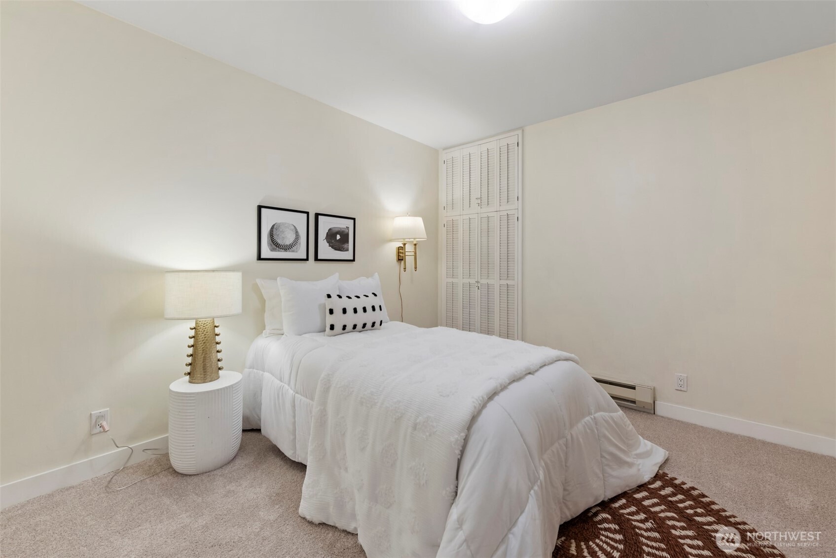 500 West Olympic Place, Unit 203 Seattle, WA 98119 - Photo 16 of 35 a bedroom with a bed and a lamp