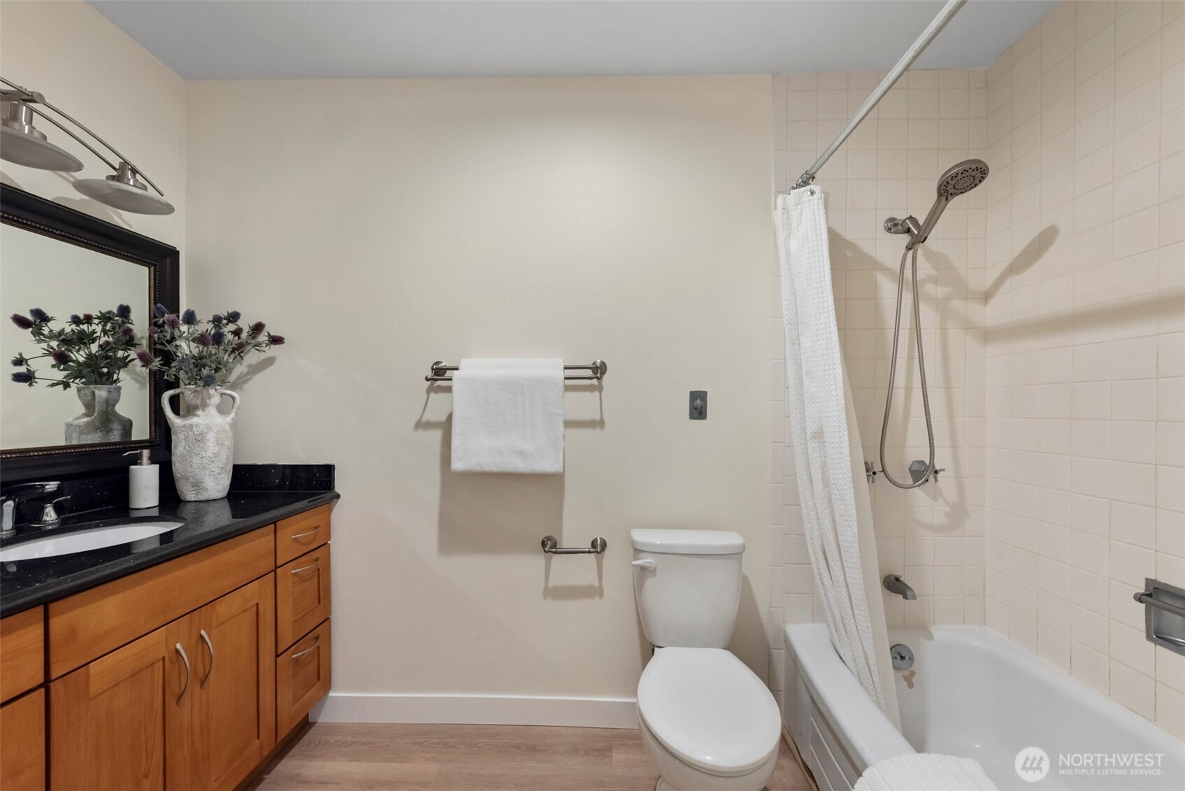 500 West Olympic Place, Unit 203 Seattle, WA 98119 - Photo 17 of 35 a bathroom with a granite countertop sink toilet and shower