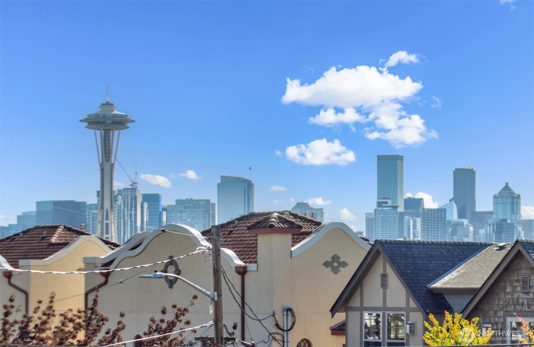 500 West Olympic Place, Unit 203 Seattle, WA 98119 - Photo 2 of 35 a view of a chandelier in a hall with a sink