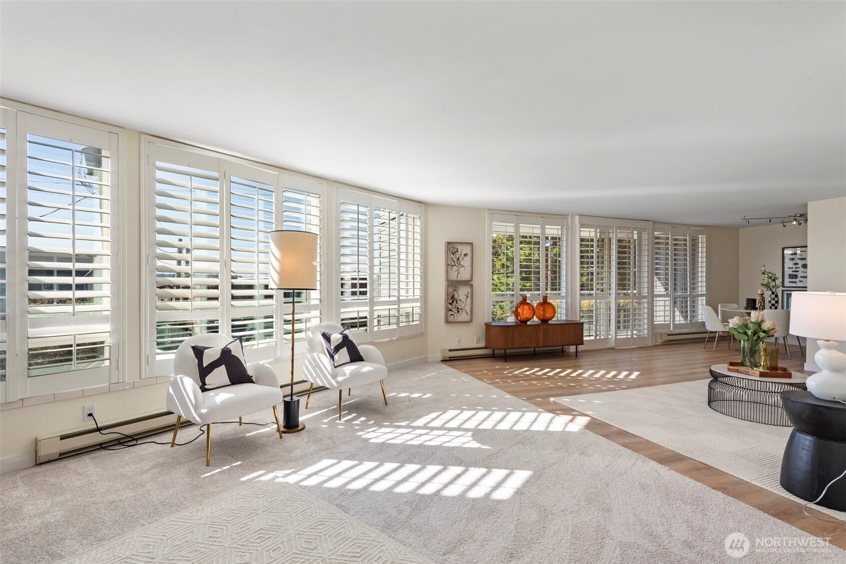 500 West Olympic Place, Unit 203 Seattle, WA 98119 - Photo 5 of 35 a living room with furniture floor to ceiling window and flat screen tv